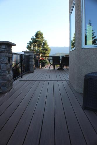 Back-Deck-Timbertech-Azek-Line-Custom-Steel-Railing-Stone-Veneer-Columns-Low-Volt-Lighting-Darian