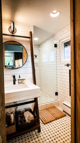 Bathroom-White-Subway-Tile-White-Shiplap-Custom-Leaning-Vanity-Mosaic-Floor-Tile-Dark-Grout