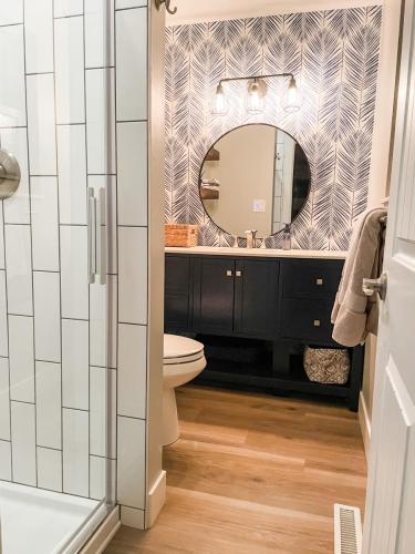Copy-of-Copy-of-Master-Bathroom-Small-Wallpaper-White-Subway-Tile-Dark-Grout-Brushed-Nickel-Finishes-Blue-Vanity-Wood-LVP-Floor-Mikado