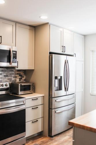 Copy-of-Grey-cabinets-space-gray-appliances-butcher-block-island-white-quartz-countertops-black-hardware-blue-and-white-mosaic-tile-backsplash-dark-grout-Rockrimmon
