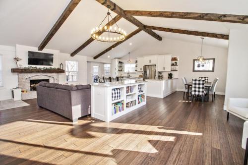 Copy-of-Open-Concept-Living-Area-Kitchen-Dining-Wood-Beams-White-Shiplap-Built-in-Bookcase-Granite-Countertop-Dining-Island-Peninsula-White-Washed-Fireplace-Wood-Mantle-White-cabinets-Black-Hardware-Dark-Hardwood-Floor-Pendant-Ligh…