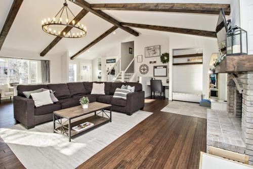 Copy-of-Open-Concept-Living-Area-Wood-Beams-Dark-Hardwood-Floor-White-Shiplap-White-Washed-Fireplace-Pendant-Lighting-Wood-Floating-Shelves-War-Eagle