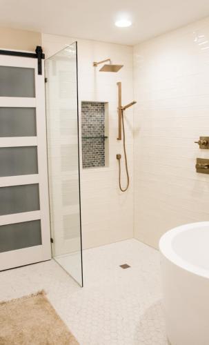Master-Bathroom-Japanese-Soaking-Tub-Brushed-Gold-Finishes-Wall-Alcove-Glass-Shelf-Glass-Shower-Panel-Zero-Entry-Shower-Cream-Wavy-Subway-Tile-Light-Grout-Modern-Glass-Bark-Door