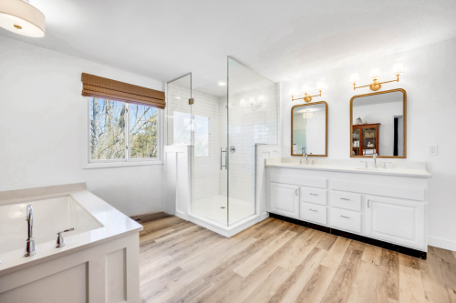 Primary-Bathroom-LVP-Floor-Brushed-Gold-Vanity-Light-Mirrors-Chrome-Plumbing-Fixtures-Walk-in-Shower-Custom-Glass-Shower-Enclosure-Quartz-Countertop-Double-Vanity-Subway-Tile-Drop-in-Bathtub-Steinbeck (1)