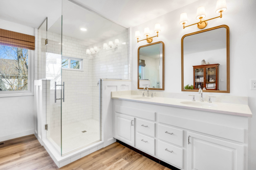 Primary-Bathroom-LVP-Floor-Brushed-Gold-Vanity-Light-Mirrors-Chrome-Plumbing-Fixtures-Walk-in-Shower-Custom-Glass-Shower-Enclosure-Quartz-Countertop-Double-Vanity-Subway-Tile-Steinbeck (1)